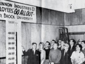 Vintage photo of McKinnon Industries employees admiring their fundraising thermometer chart.