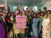 A photo of union leaders and the joint delegation standing in solidarity at the BCWS offices in Dhaka