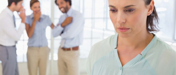 Photo of woman looking away for others talking behind her back