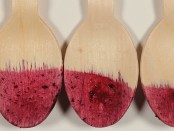 Image of wooden spoons stained by blueberry puree.