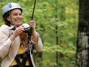 Image of teen zip lining in the forest