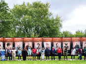 Image of a group of people in front of Patterson Park Black historic Murals.