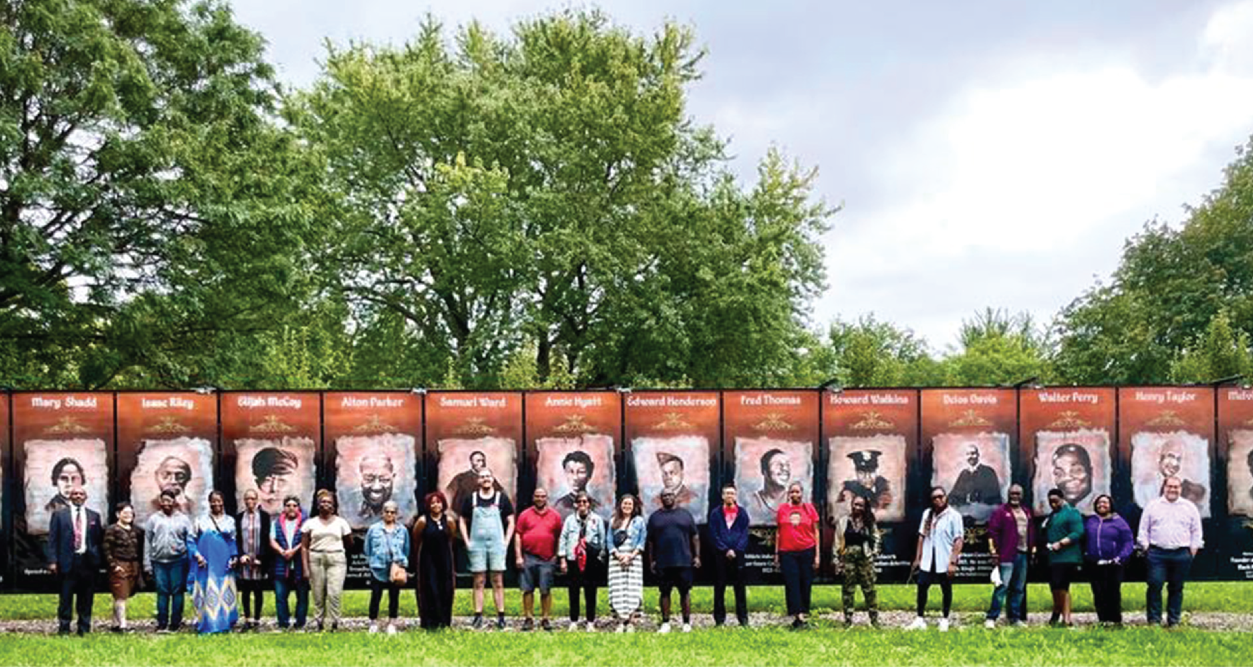 Image of a group of people in front of Patterson Park Black historic Murals.